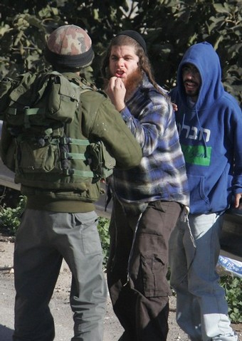 A Jewish settler argues with an Israeli border policeman during riots near a disputed house in the flashpoint West Bank city of Hebron December 2, 2008. At least 13 Palestinians were wounded overnight as more than 1,000 ultra-nationalist Israelis hurled rocks at residents, homes and police jeeps in the flashpoint West Bank city of Hebron. The rioting broke out as rumours spread that security forces were set to evict 100 Jewish settlers from a house the Israeli high court has ordered evacuated. The Israeli High Court on November 16 ordered the settlers to leave the Hebron house in which they have lived since March 2007, but security forces have not enforced the order to date. From Getty Images by AFP/Getty Images.