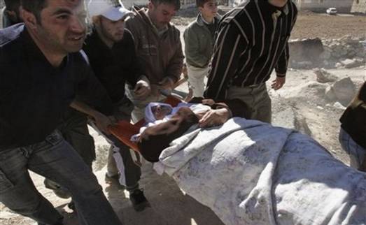 A Palestinian woman is evacuated after she was injured during clashes in the West Bank city of Hebron, Tuesday, Dec. 2, 2008. Dozens of Jewish settlers rioted Tuesday in the West Bank town of Hebron, clashing with the Israeli troops who guard them but who may also soon evict them from a disputed building they